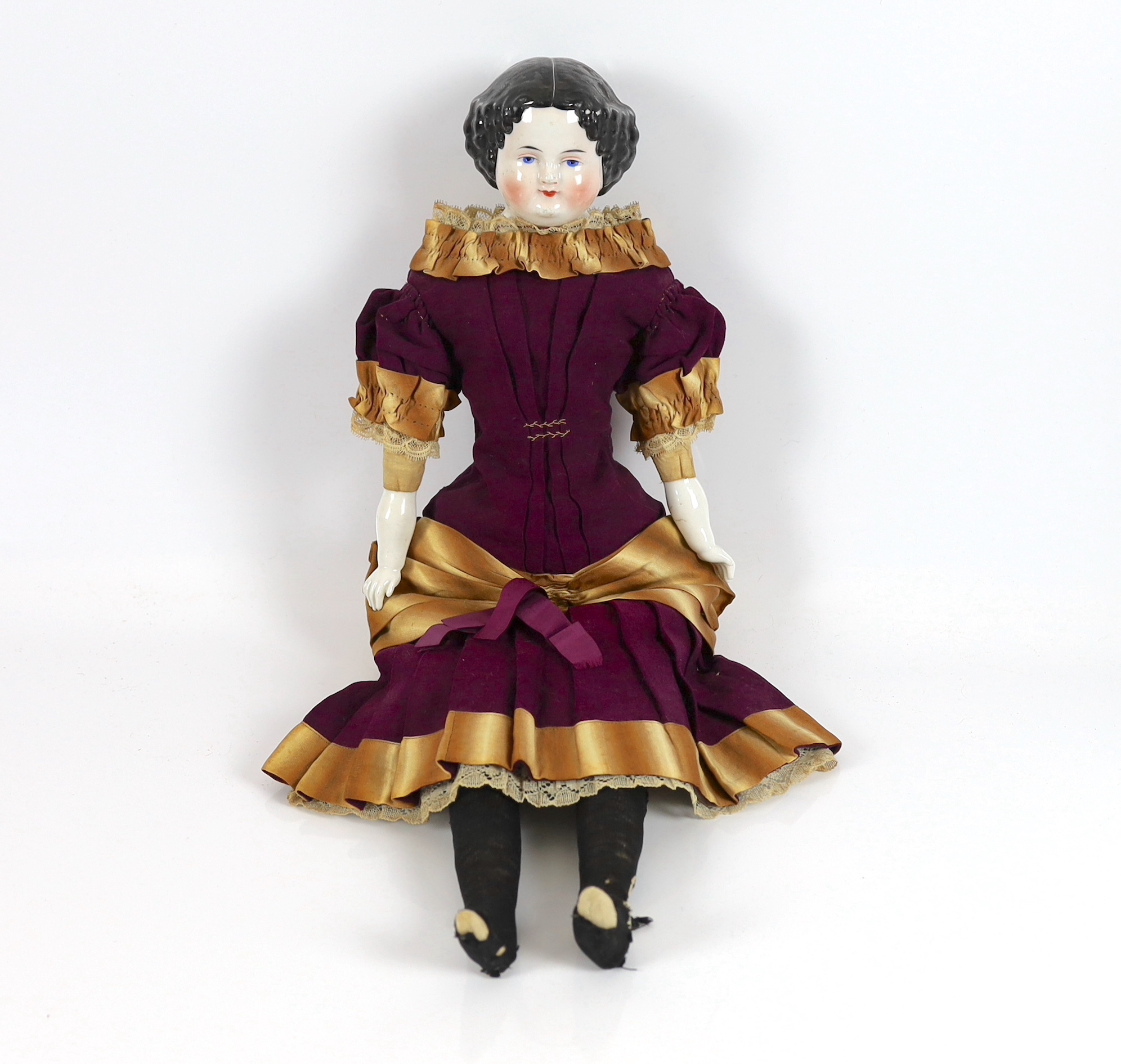 A glazed shoulder china head doll, c.1870, 53cm, some rubbing of hair, cloth body, original dress in very good condition